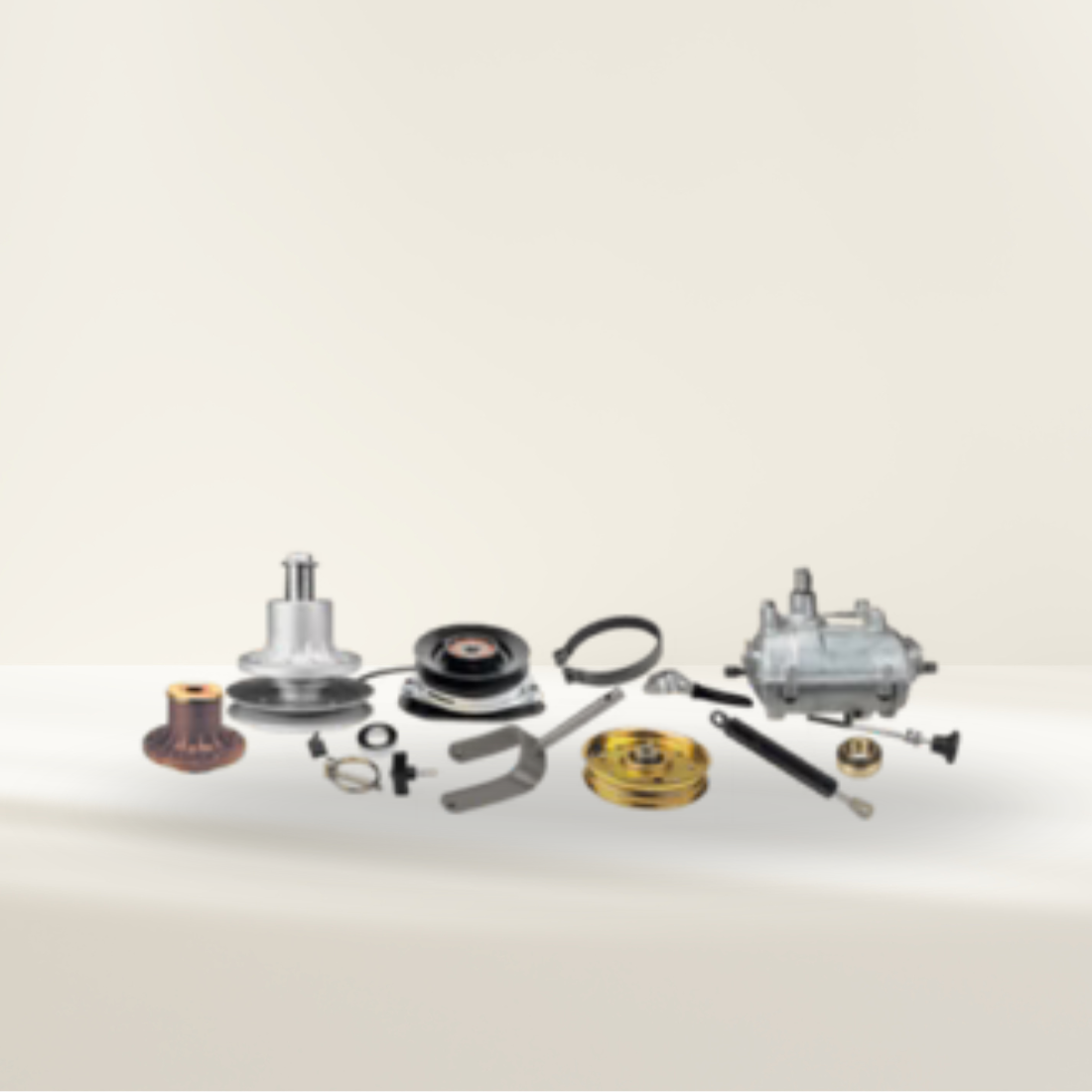Collection of mechanical lawn mower deck parts on a beige background
