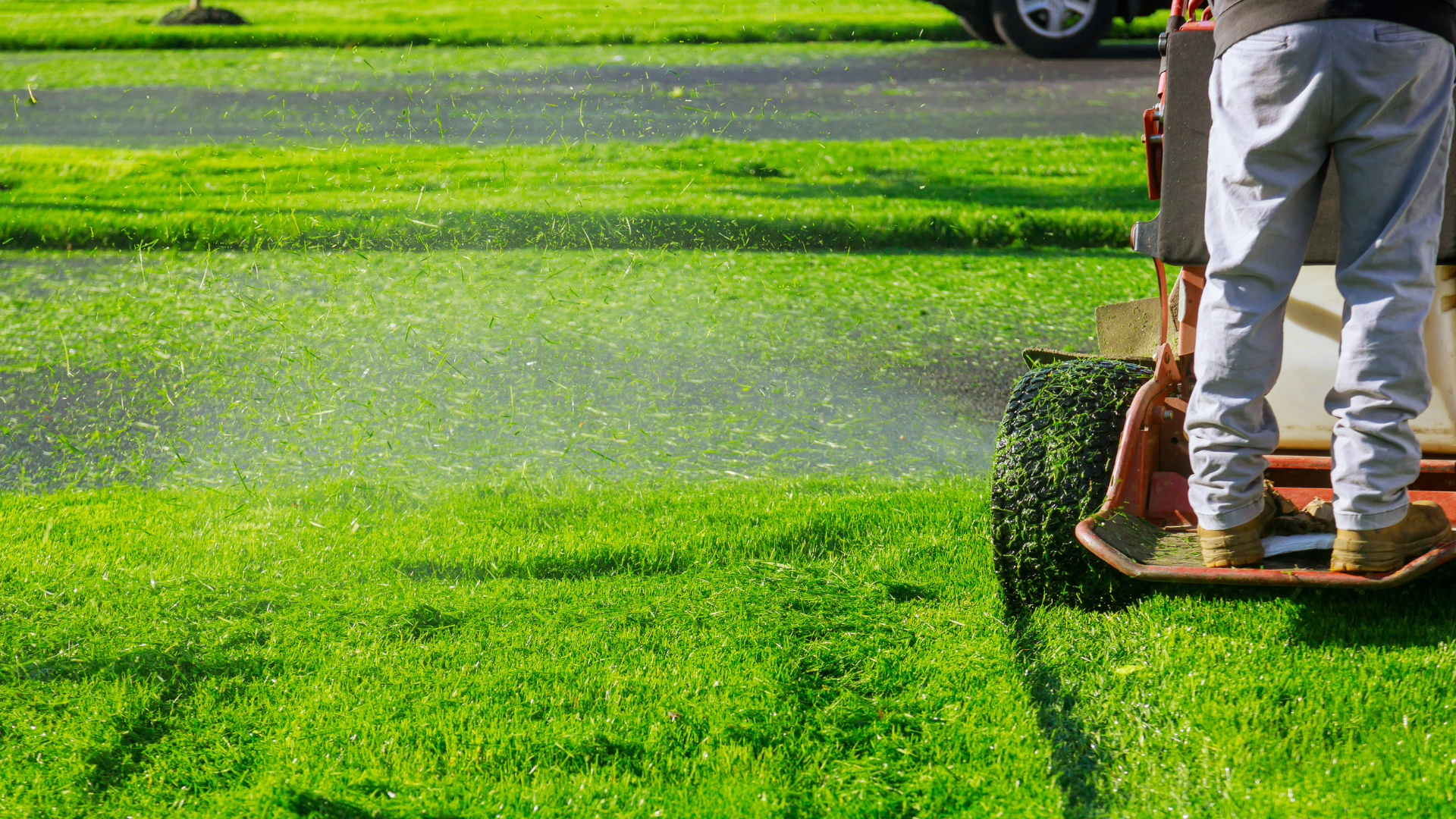 Man on Zero Turn Lawn Mower Mowing Grass